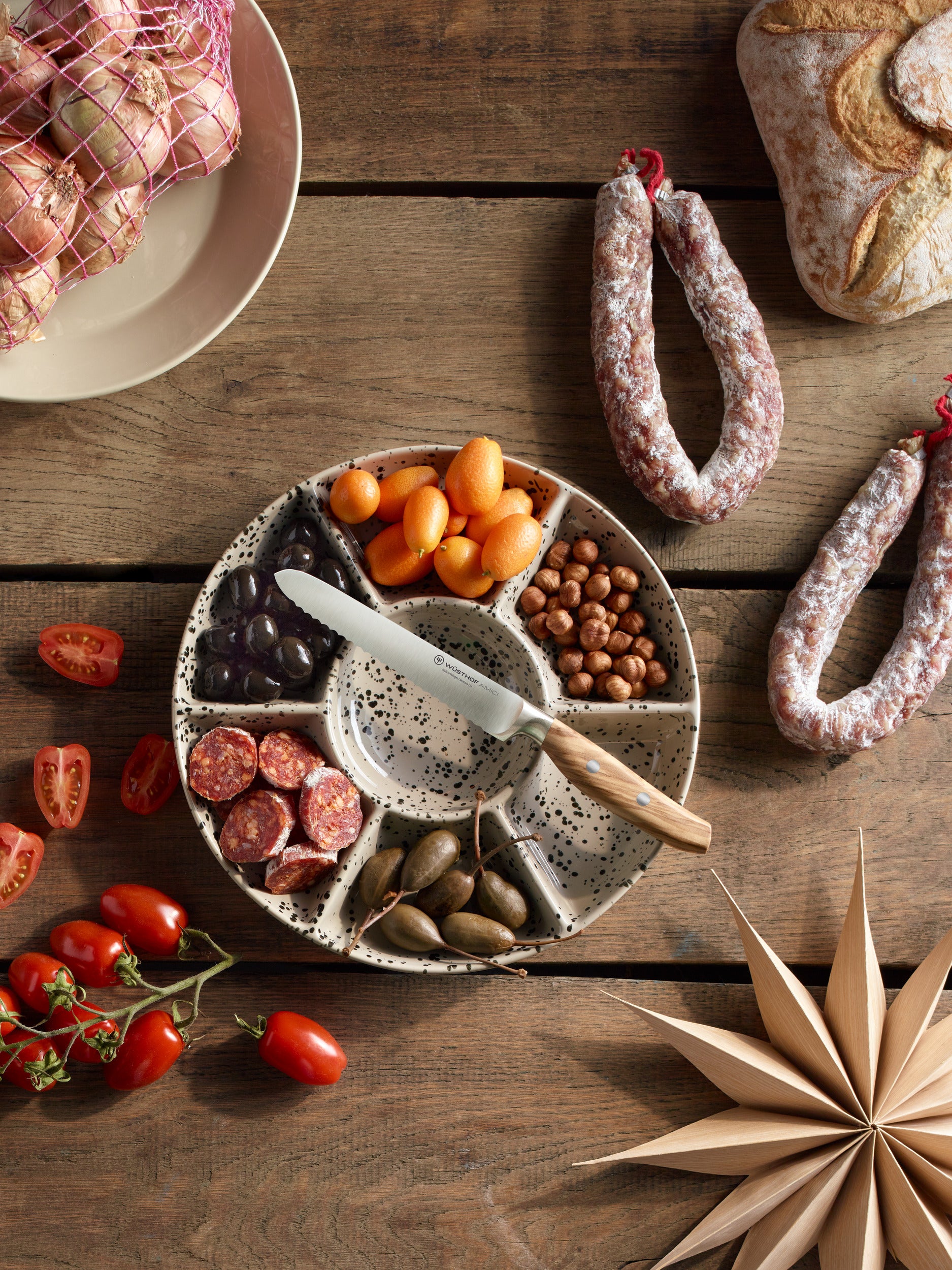 Assorted meats, olives, and bread on a wooden table