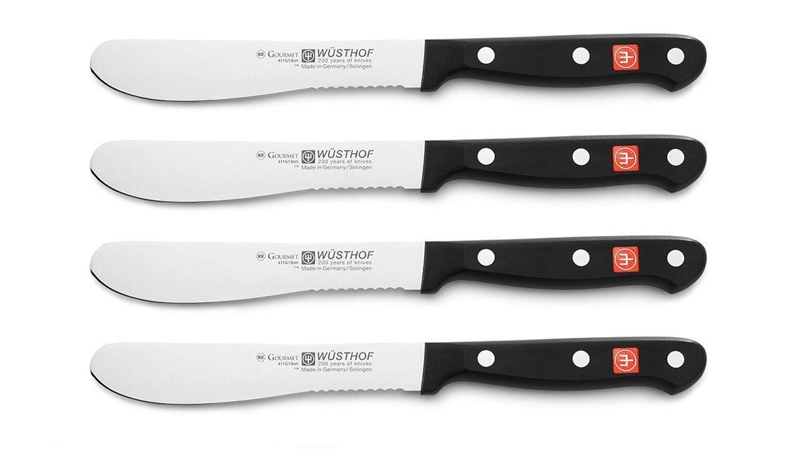 Set of four Wusthof knives on a white background
