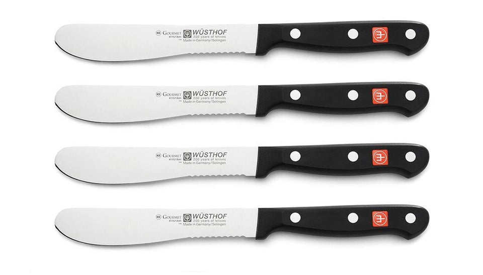 Set of four Wusthof knives on a white background