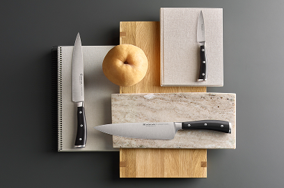 Knives and a cutting board on a gray background