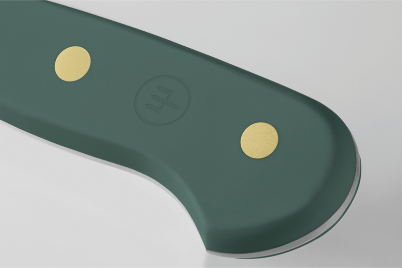 Green tool handle with gold accents on a gray background