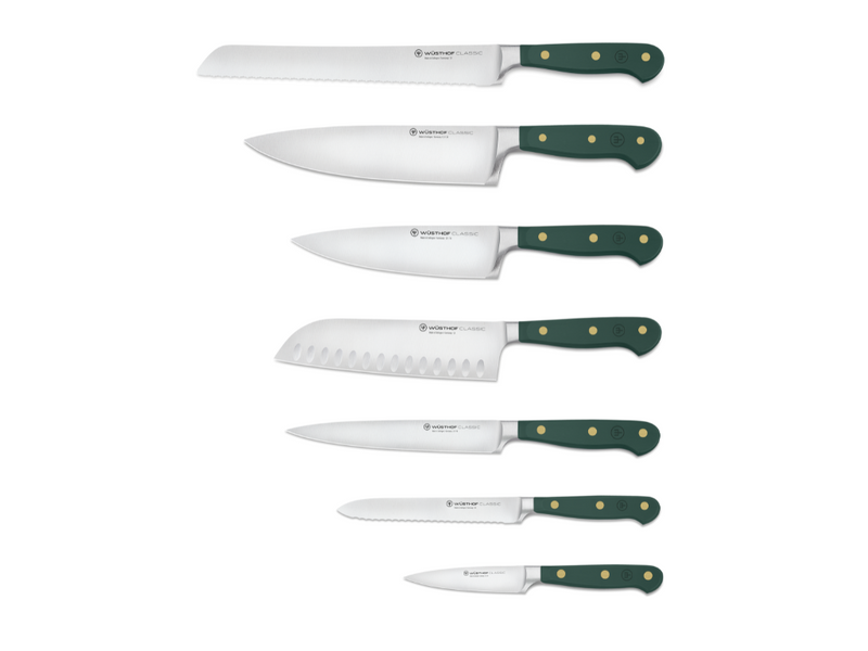 Set of knives with green handles on a white background