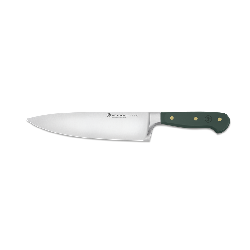 Chef's knife with a green handle on a white background
