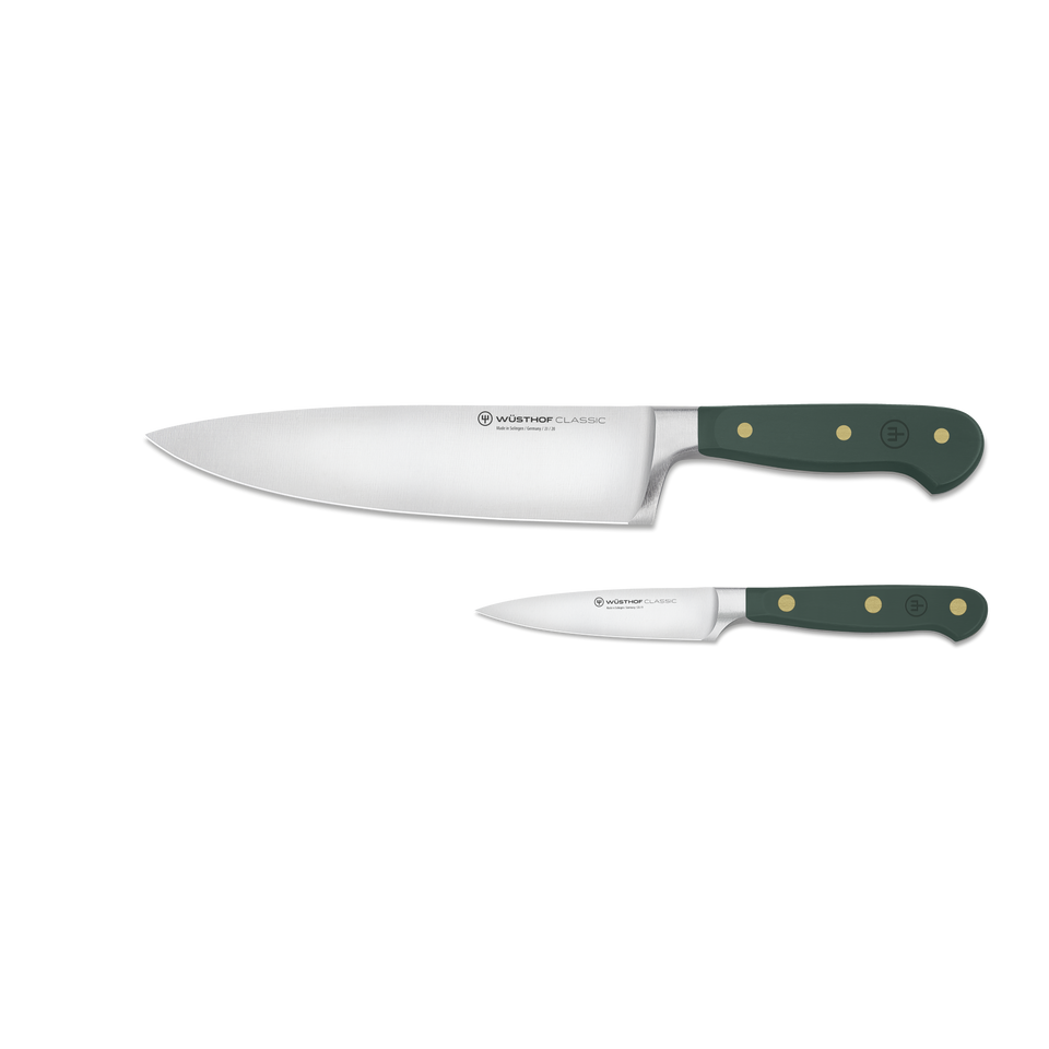 Two knives with green handles on a white background