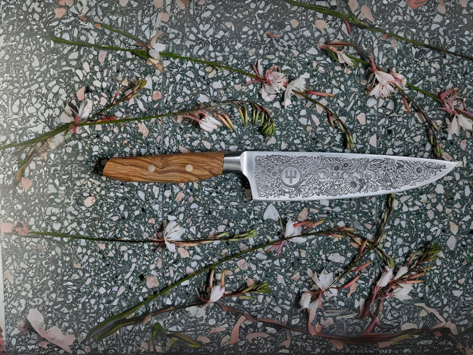 Knife with a wooden handle on a surface with flowers and leaves