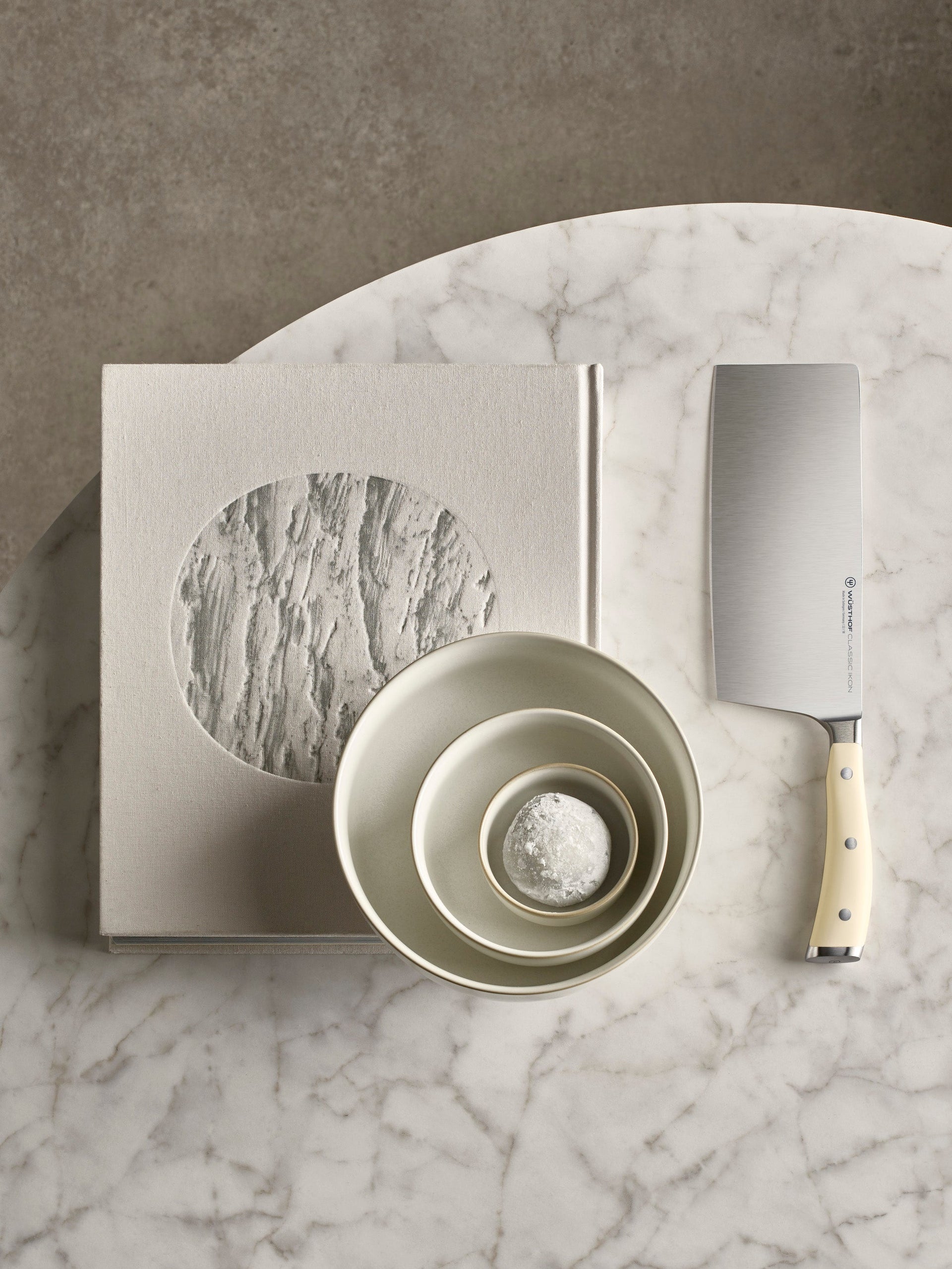 Set of bowls and a knife on a marble surface