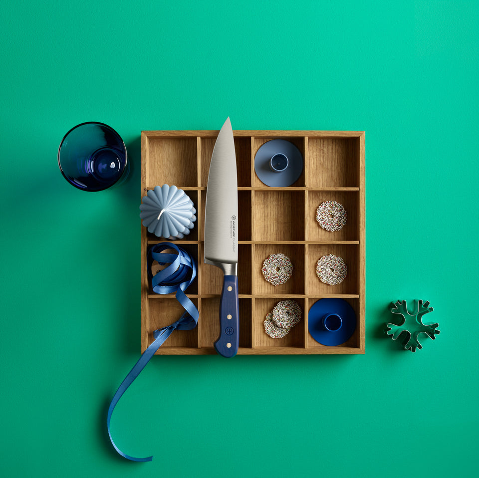 Wooden box with decorative items on a green background