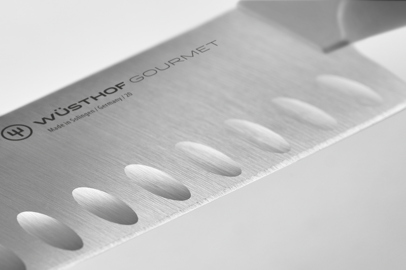 Close-up of a Wüsthof Gourmet knife blade with brand logo.