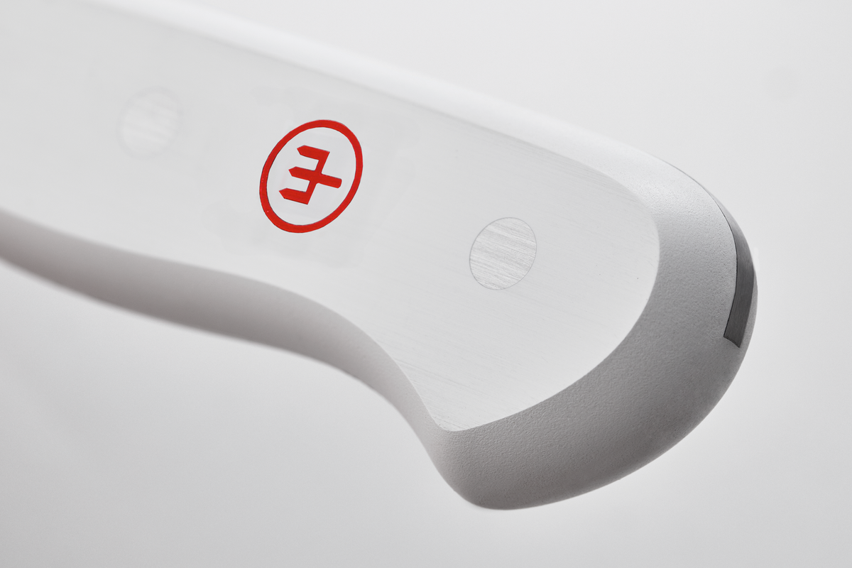 Close-up of a white electronic device with a red logo on a light gray background