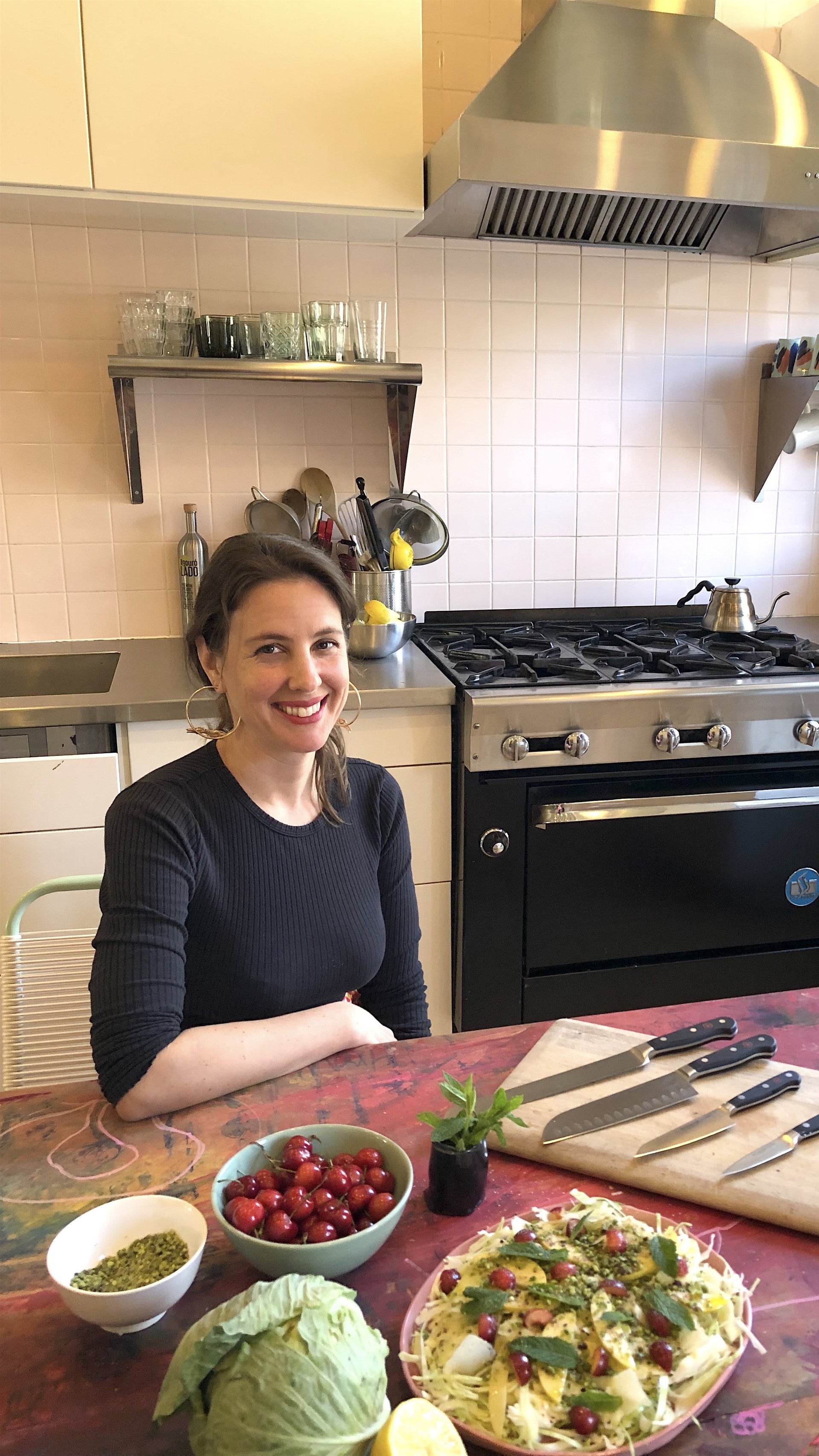 Chef Mina Stone sitting in her kitchen