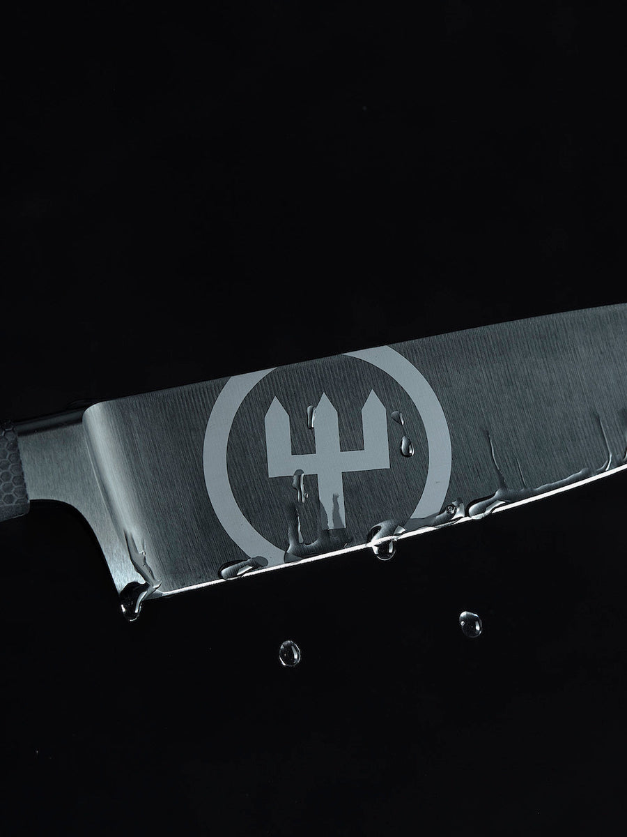 Close-up of a metallic object with a logo on a black background