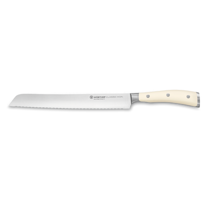 Classic Ikon 9" Precision Double-Serrated Bread Knife with a long forged German steel blade and smooth ivory triple-riveted handle for precise slicing.
